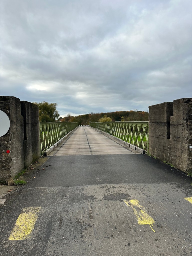 An historic wooden bridge over a river in North Yorkshire.